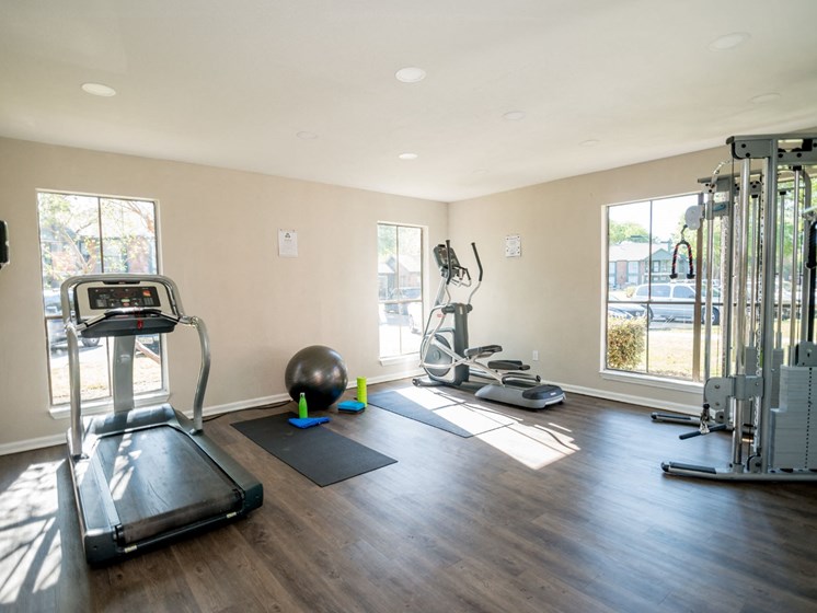 Fitness center with treadmill and other gym equipment.